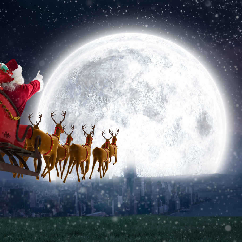 Santa,Claus,Riding,On,Sleigh,With,Gift,Box,Against,Bright